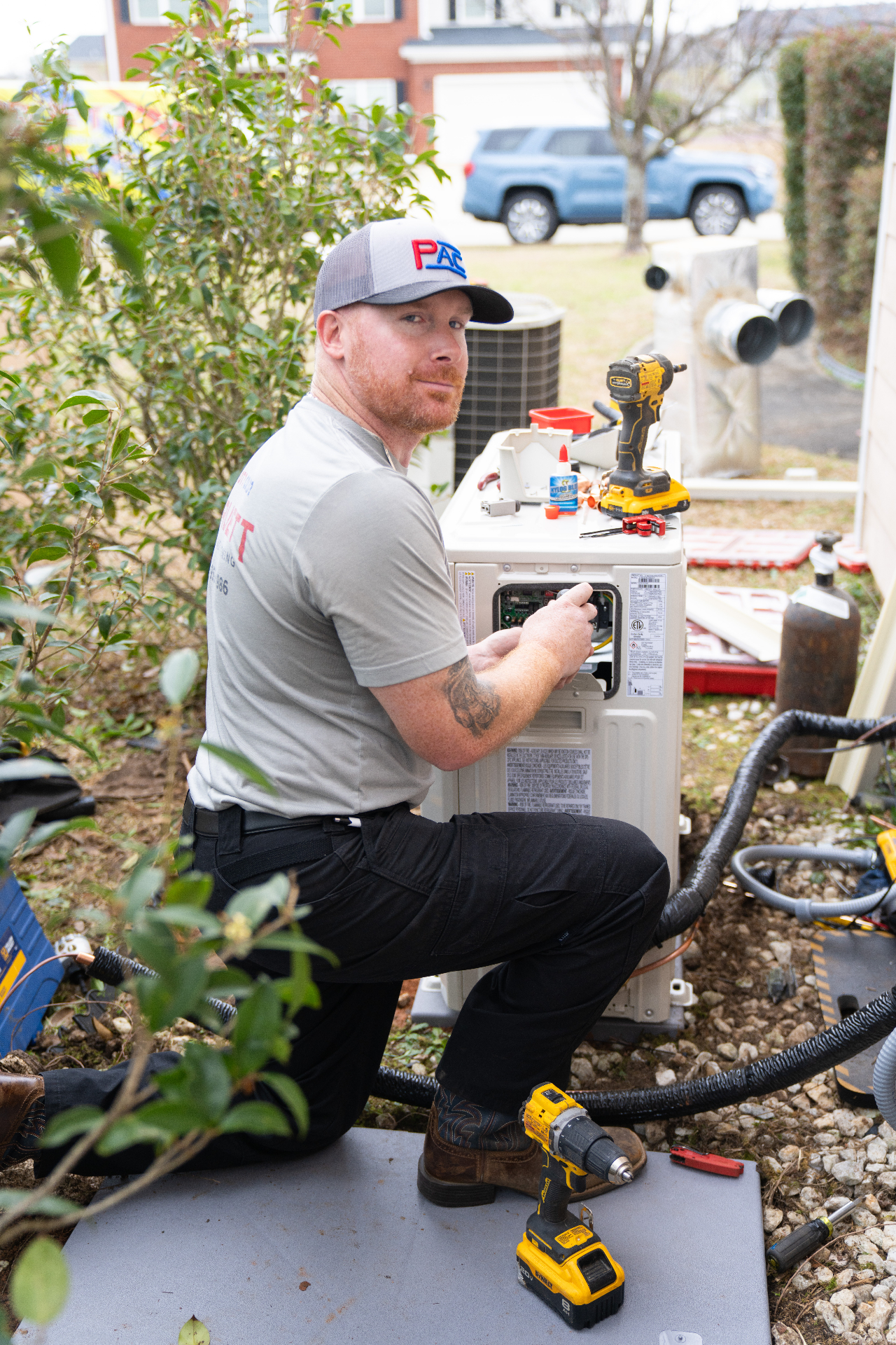 Pruett AC technician servicing an air conditioner in Warner Robins, GA